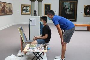 teacher with student in gallery