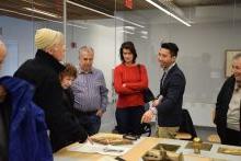 Hoang Tran guides a member tour of the PAFA archives.