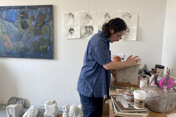 Eric Wagner in his studio sharing marble sculpture